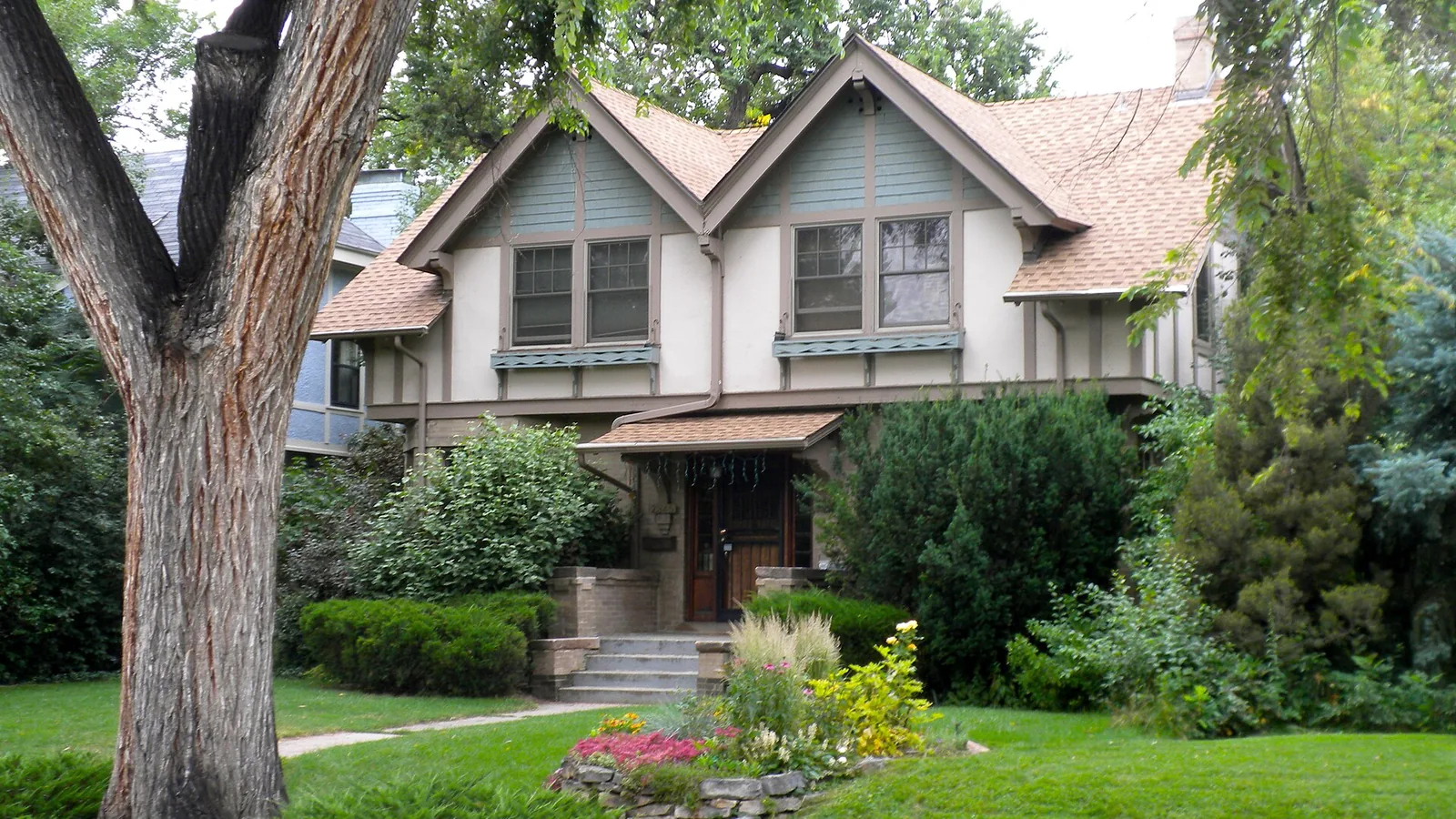 Aerial view of Park Hill Denver showing historic bungalow homes with mature trees and City Park nearby